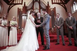Young Christians exchanging vows while facing each other and holding hands