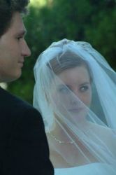 A pretty Christian bride in a veil is shown with her husband as they get married