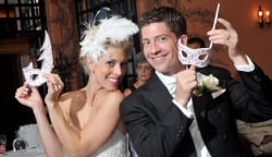 Beautiful model couple unmasked at masquerade wedding