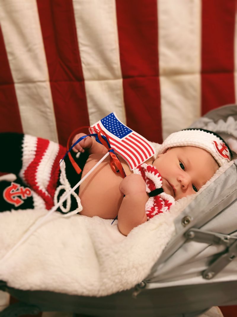 Newest Patriot holds American flag