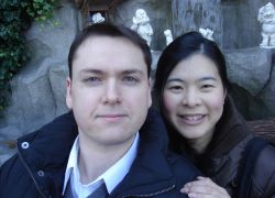 Christian single man from Ontario looks very pleased to meet a beautiful Asian Christian woman, who leans over his shoulder and smiles