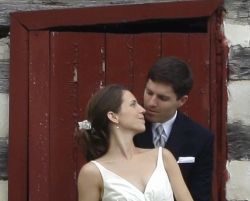 Virginia Christian single has best day of her life after marrying. A woman leans back against a door to kiss a man in a nice suit
