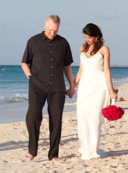 A couple walk hand in hand in thought after marrying in Turks and Caicos