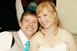 A young Christian couple laughing and leaning in together just after marrying