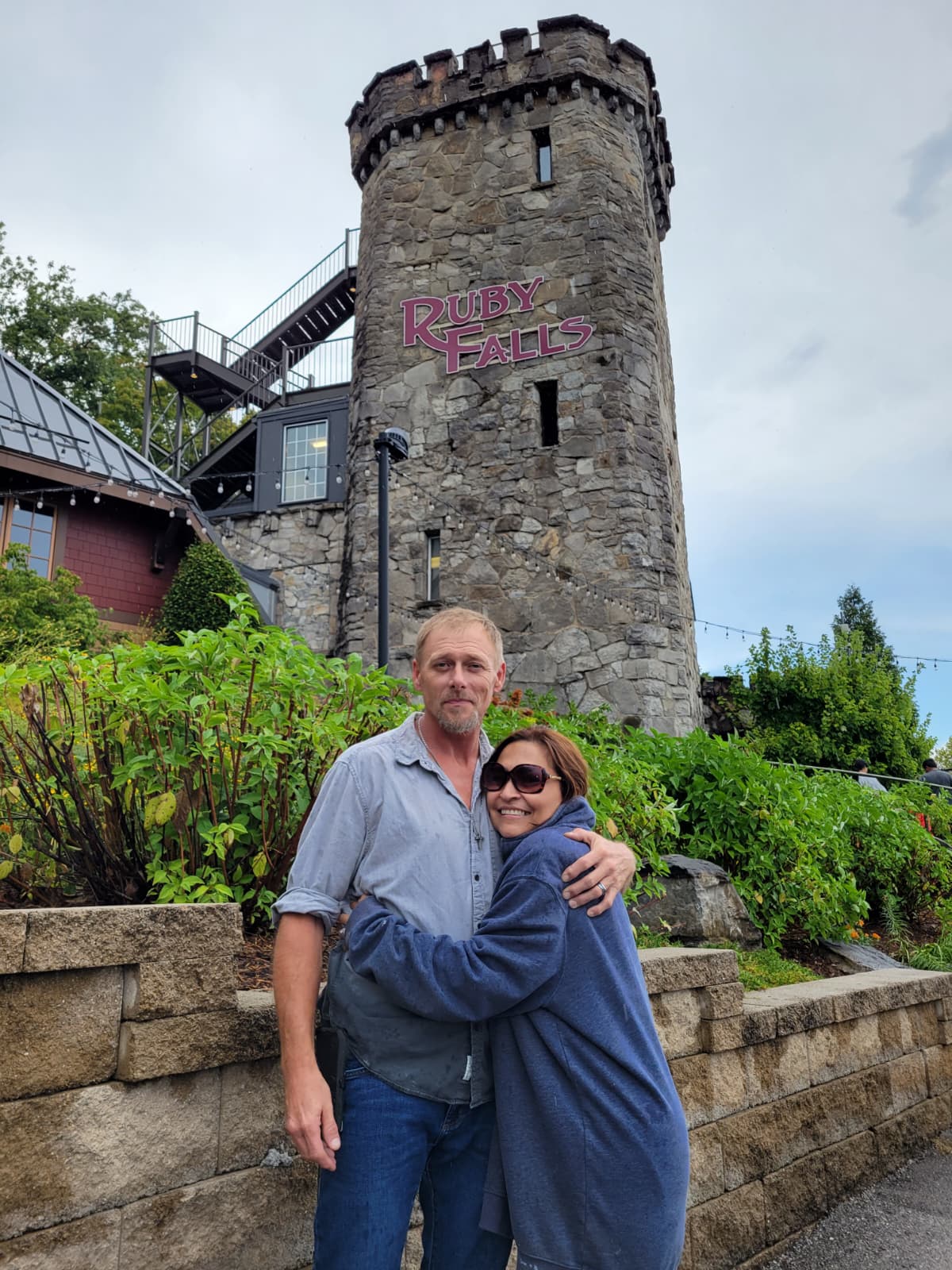 A Christian couple hug in Ruby Falls, TN