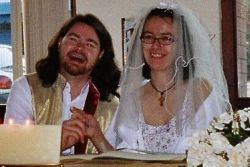 Peter holds Jana's hand as both laugh joyfully on their wedding day