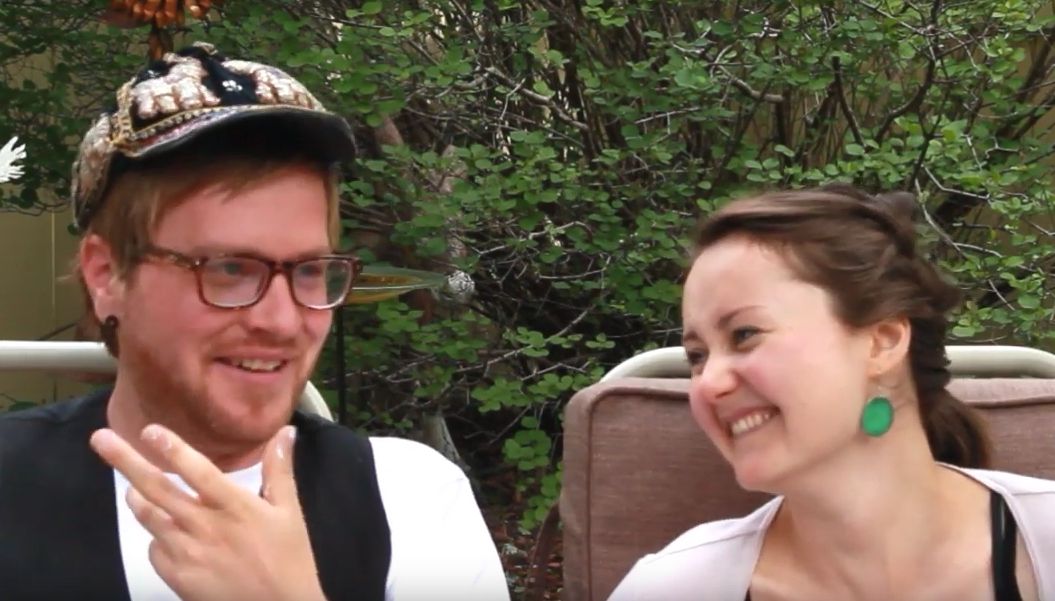 Man looks embarrassed after telling a joke while a woman laughs