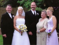 A man can't stop smiling after marrying a beautiful Christian woman as both are surrounded by family