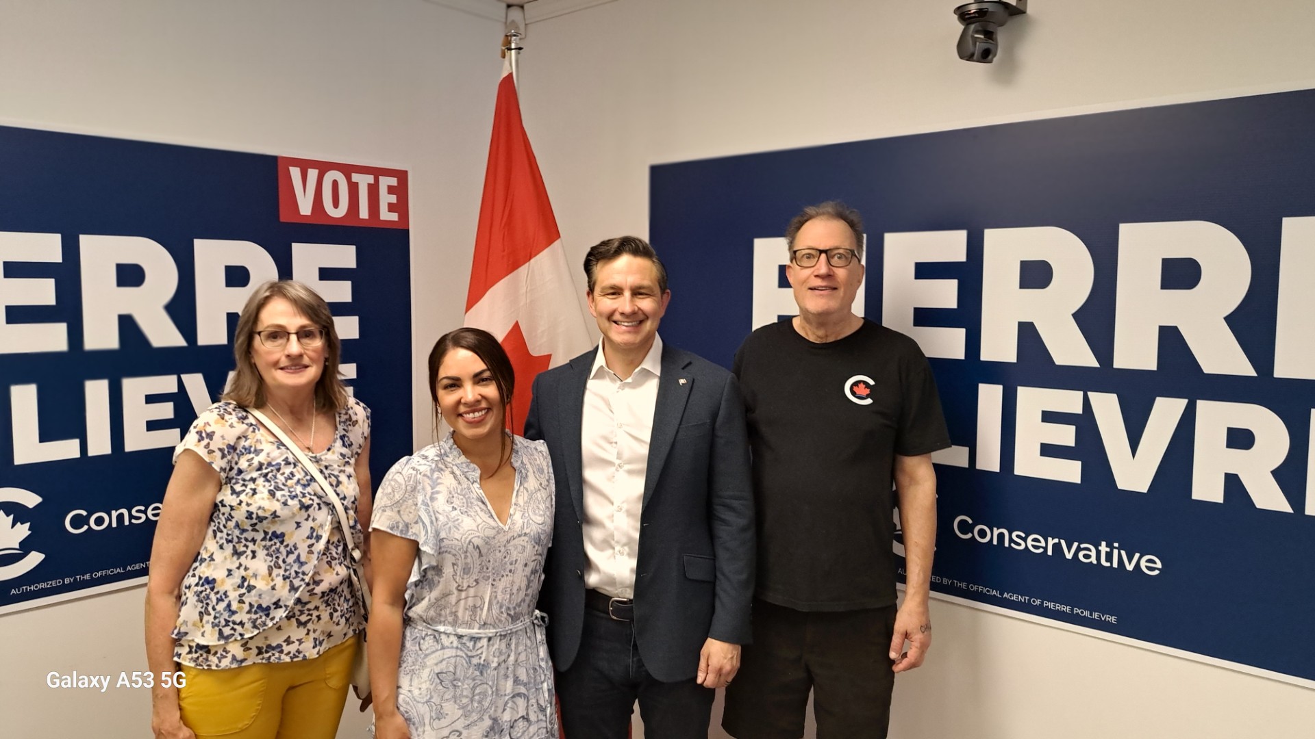 A Christian couple in Calgary pose with Pierre Poilievre