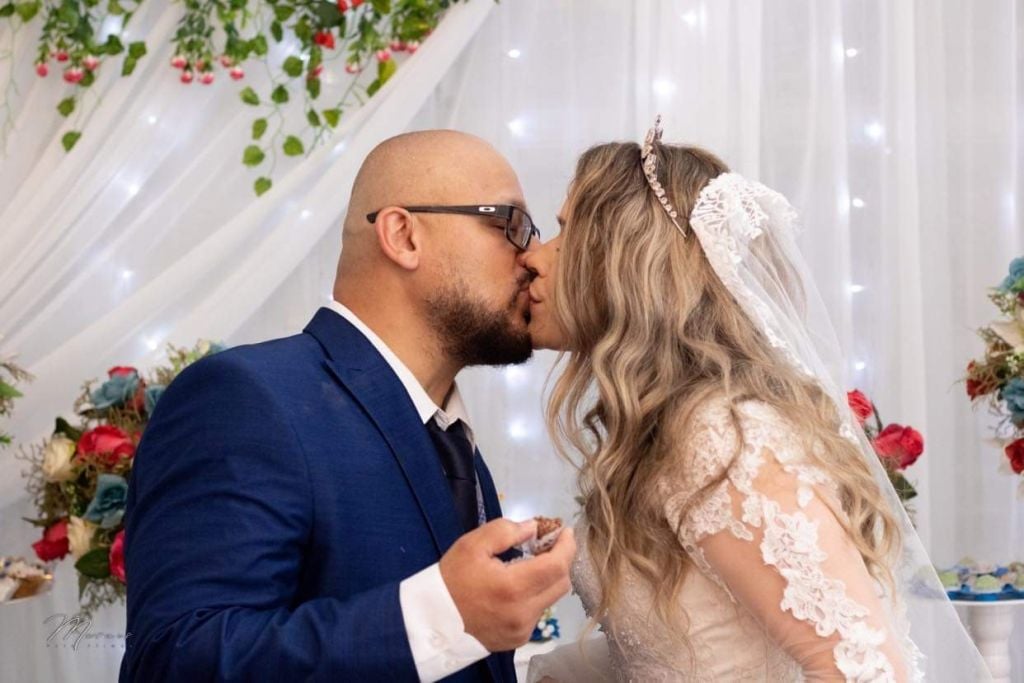 Attractive Christian couple kiss on their wedding day