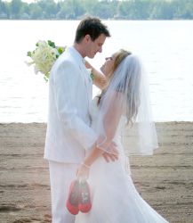 Christian newlyweds gaze into each other's eyes by the Great Lakes