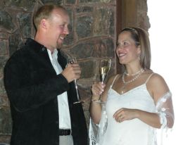 A pretty bride toasts her new husband who laughs with her