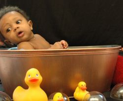 Cute baby in tub with ducks