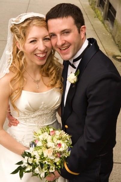 Newly married Christians laughing while looking at camera