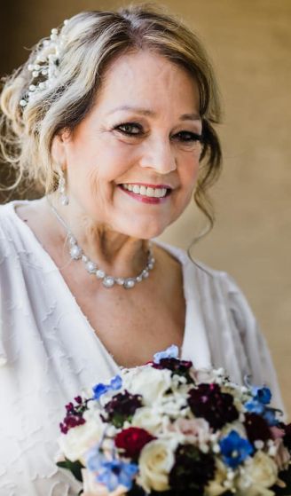 Beautiful senior Christian bride smiling holding bouquet