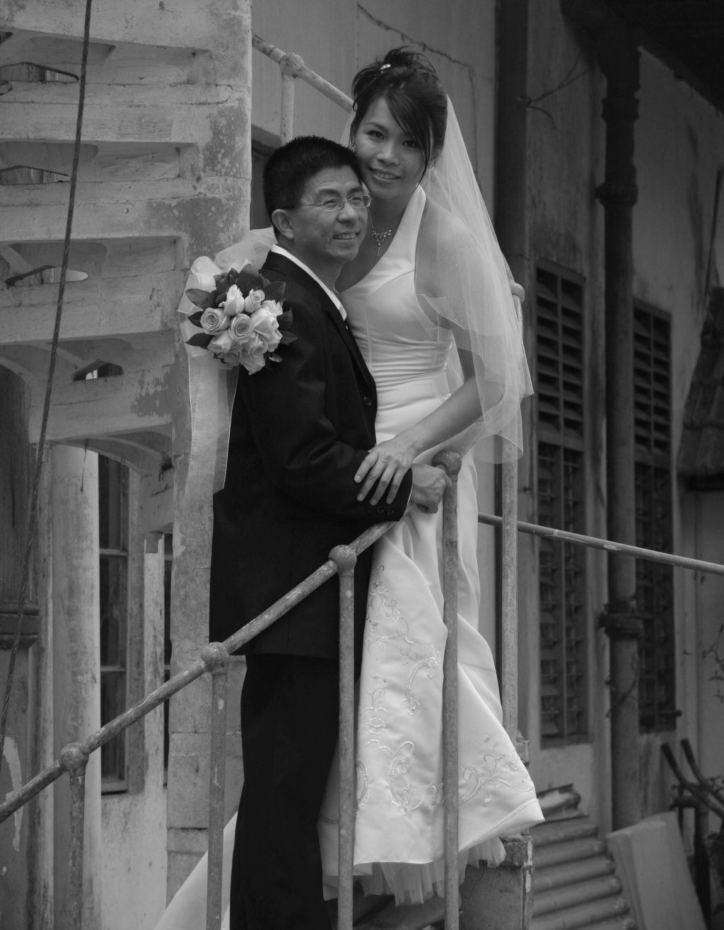 Man on stairs holding his beautiful Christian bride
