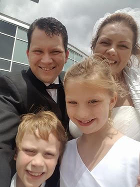 Blended Family selfie for newly married couple and their smiling children