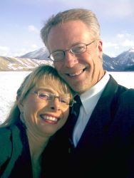 Newly engaged Christian singles smile together in beautiful mountain scenery