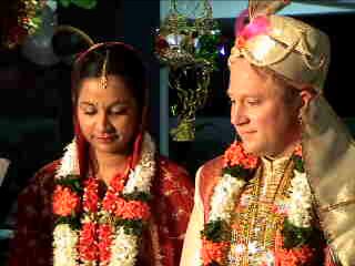 Christian couple in flowers for traditional Indian wedding