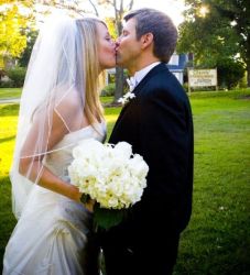 A beautiful woman kisses groom on their Wedding day