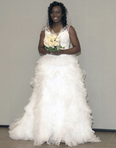 Beautiful bride in white dress posing with her bouquet of flowers 