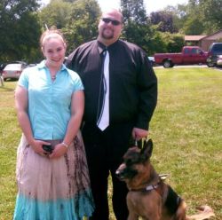 Groom with a seeing eye dog smiles while standing next to his beautiful Christian fiancee