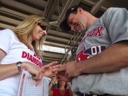 Christian single puts an engagement ring on his excited new fiancee at a Red Sox game