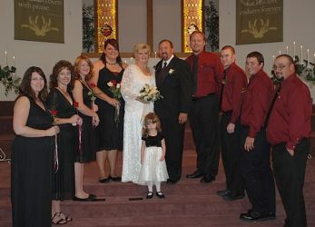Large wedding party poses with bride and groom at church