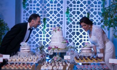 Excited couple preparing to cut Wedding cake