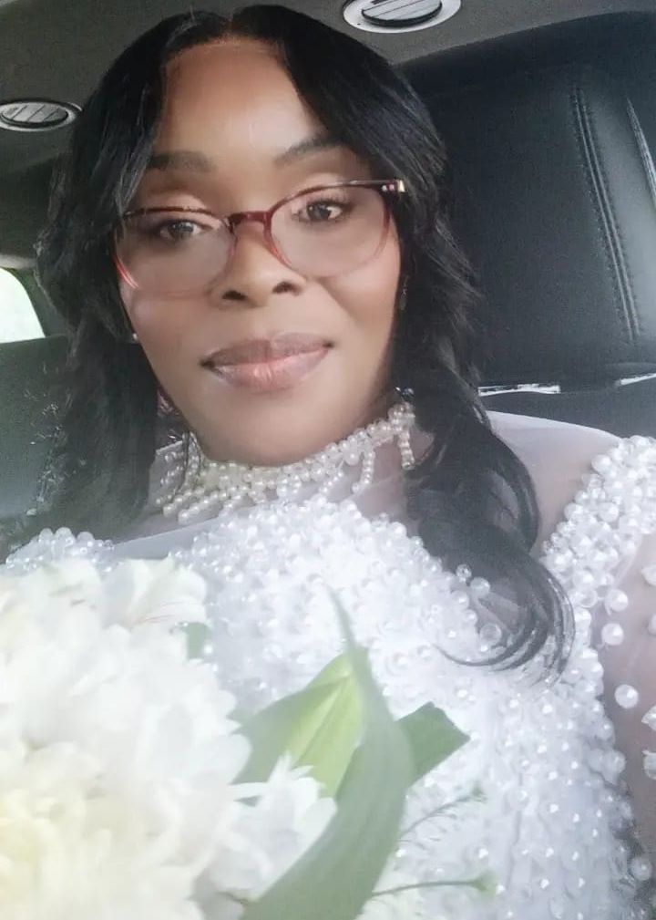 A bride holding her bouquet is pictured in a limousine