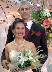 A tall Christian man stands behind his beautiful Filipina wife